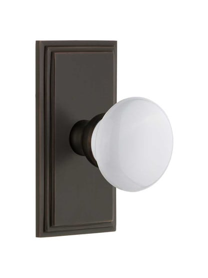 Grandeur Carre Rosette Door Set with Hyde Park White Porcelain Knobs in Timeless Bronze.